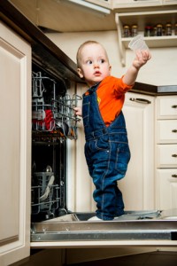 Baby helping unload dishwasher