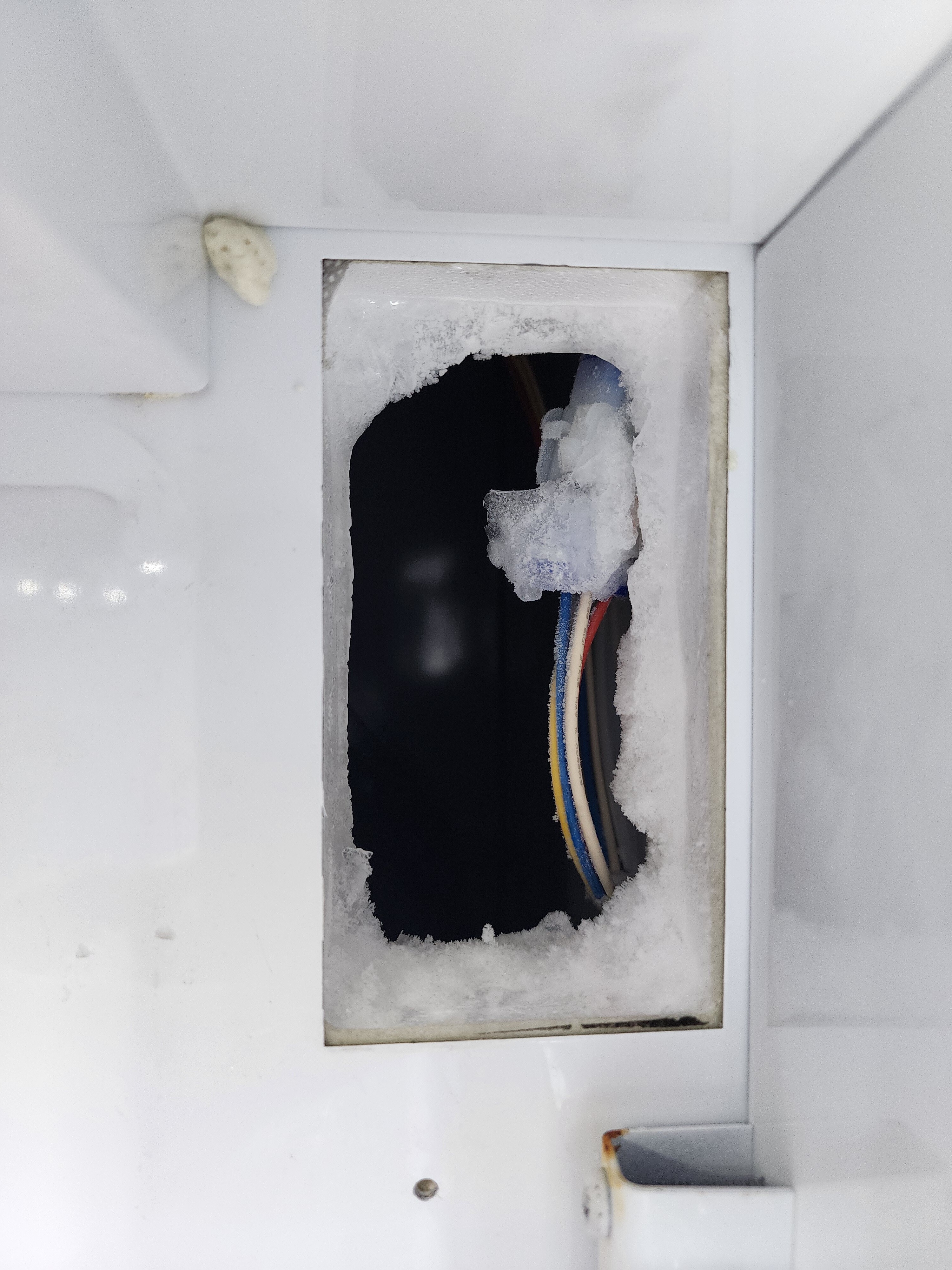 Interior access port showing wiring where the defective GE Profile refrigerator damper was removed in Parkland FL RR0106