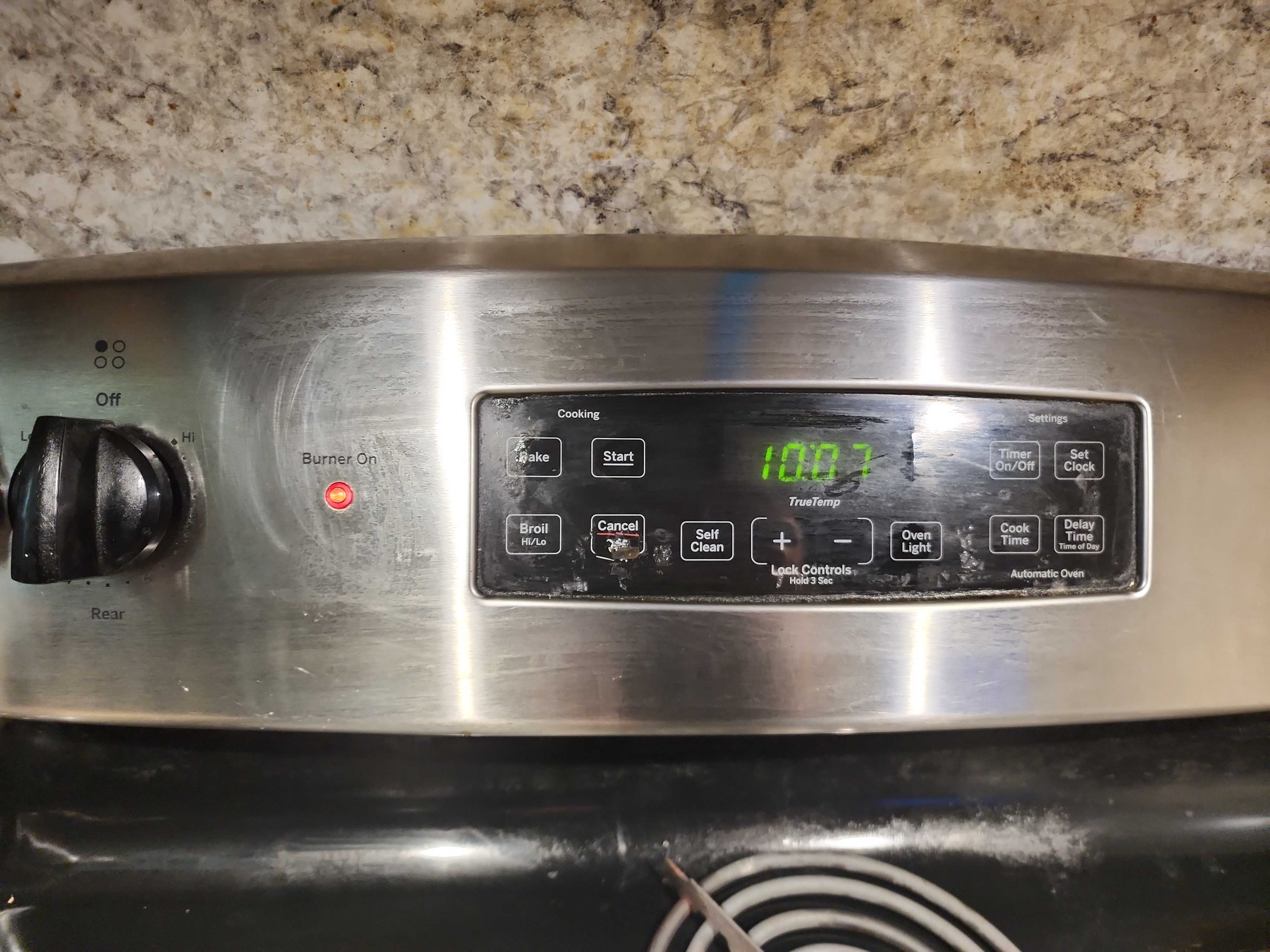 GE JB255RJ1SS electric range control panel showing hot burner light indicator in Pompano Beach FL RR0097