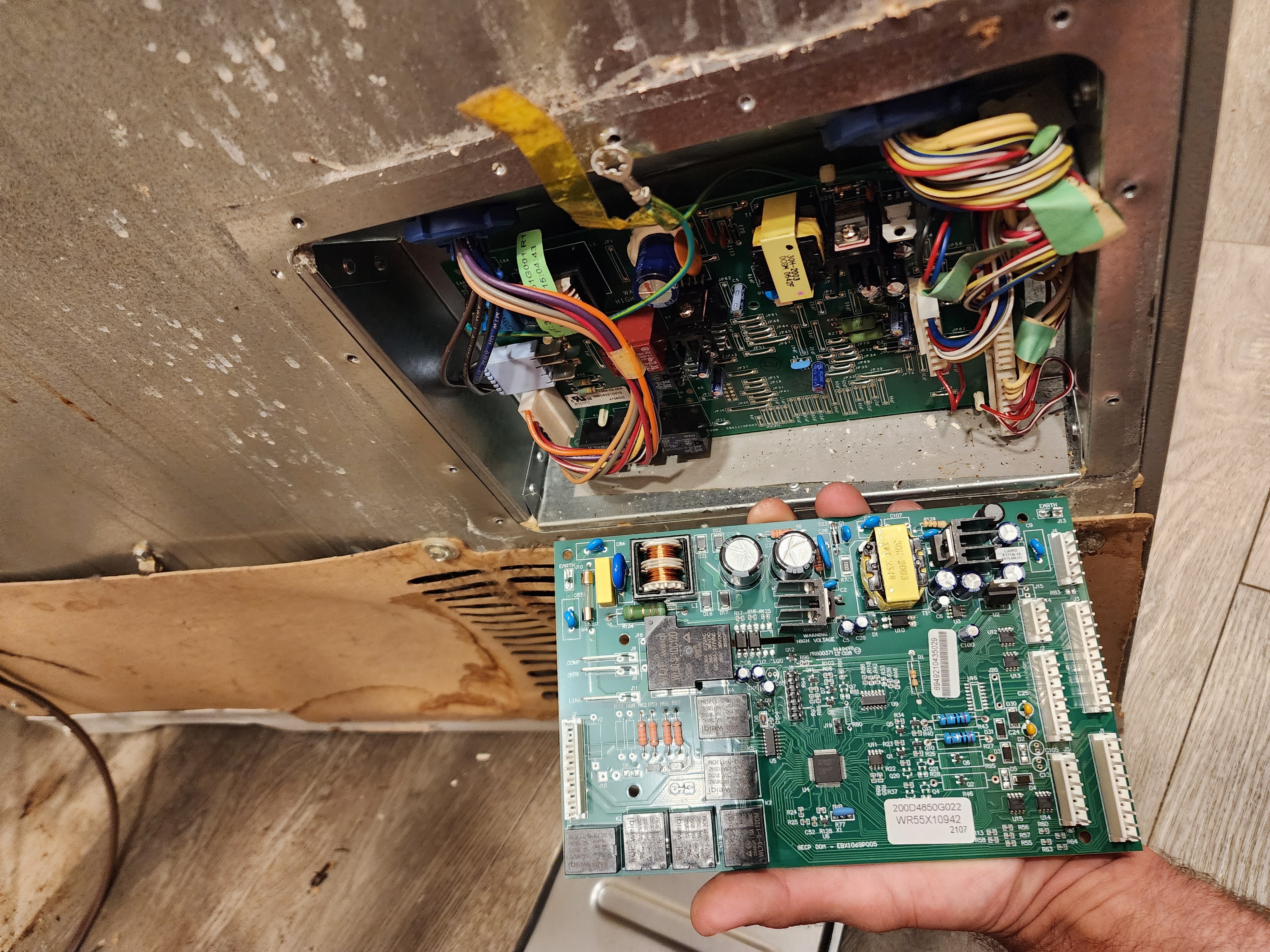 Technician diagnosing GE refrigerator control board failure in Margate FL RR0099