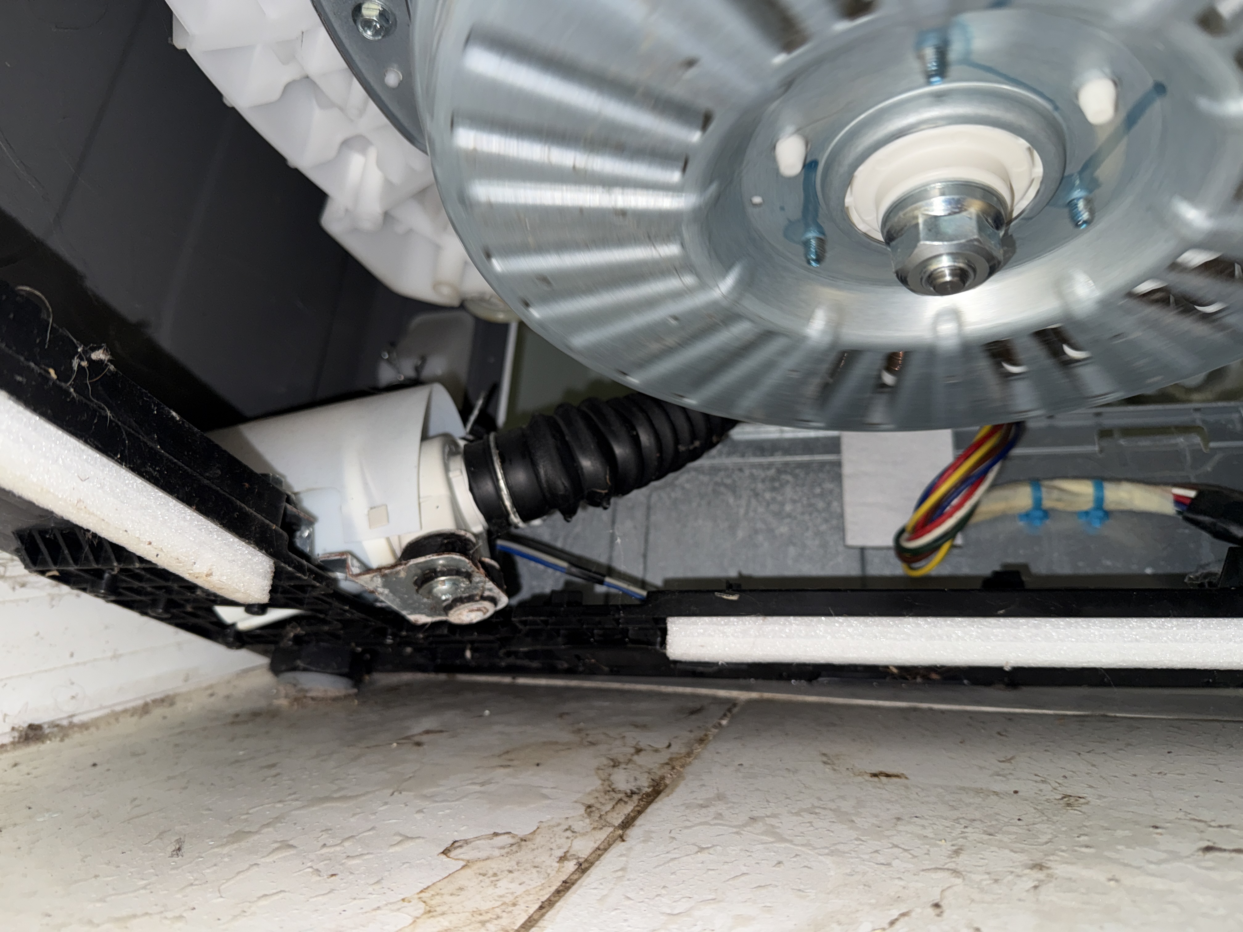 LG WT4870CW top-load washer drain hose repair area underneath appliance in Oakland Park FL RR0095