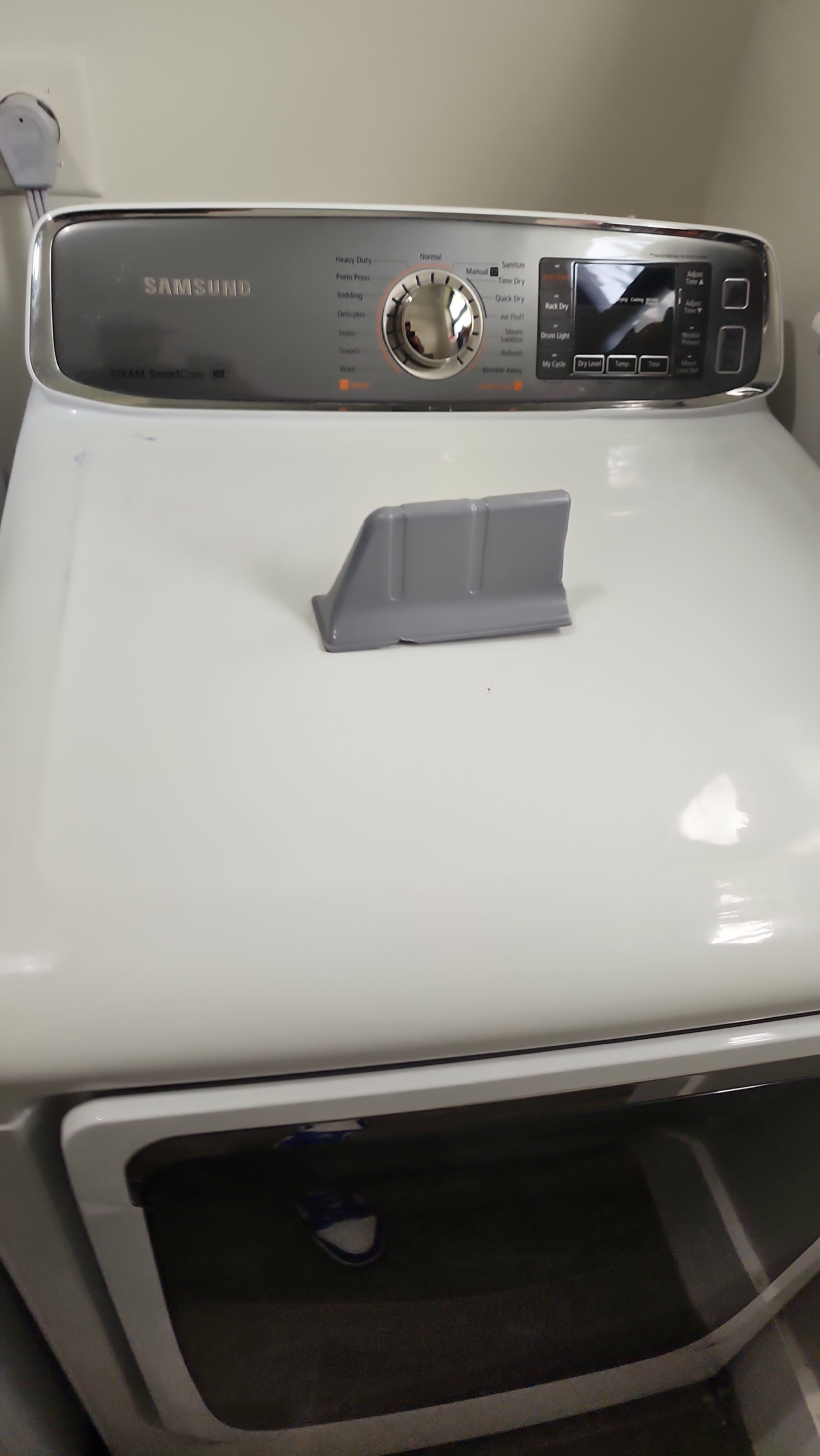 Samsung dryer damaged drum baffle resting on top of appliance in Coral Springs FL RR0113