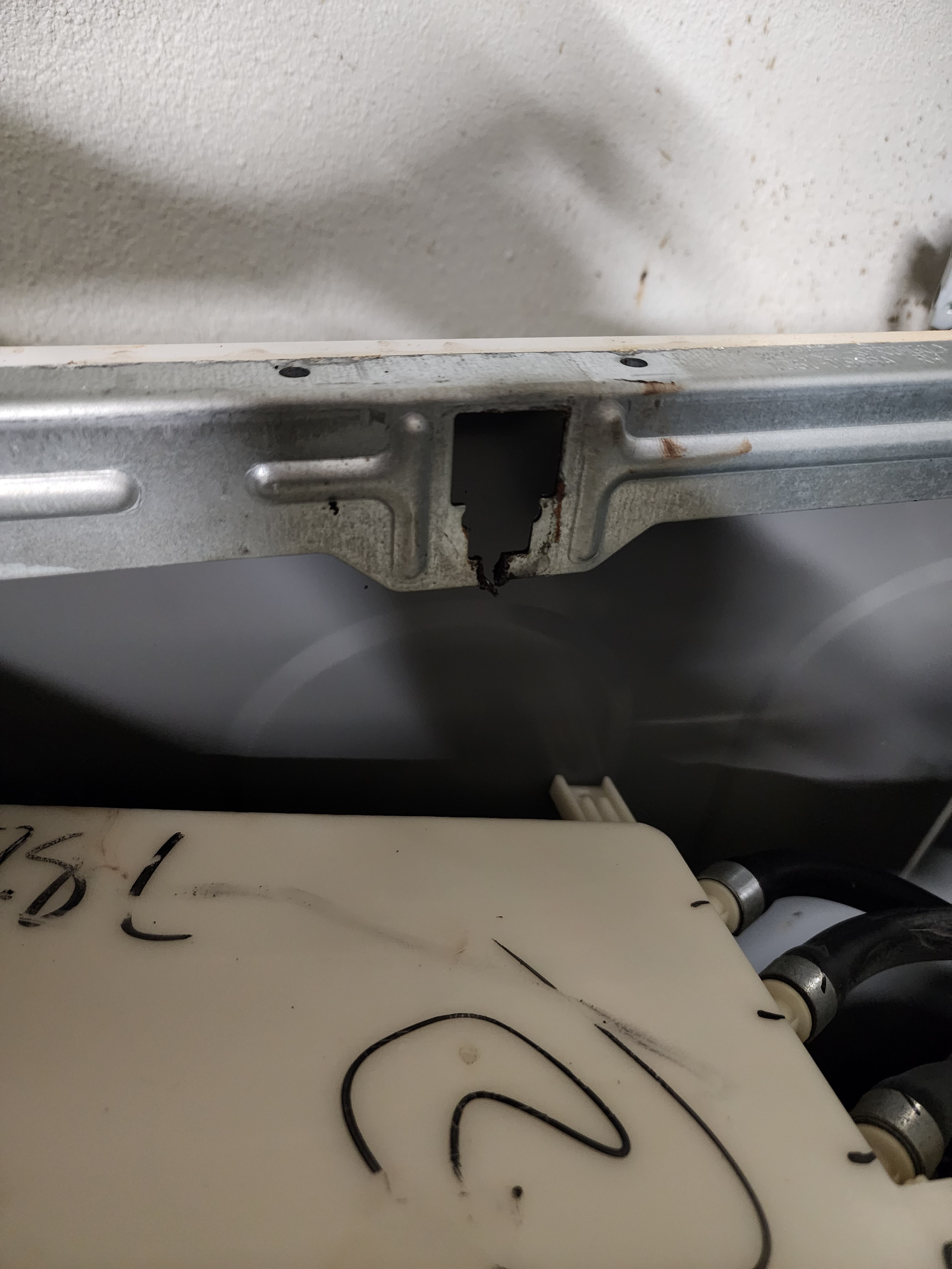 Samsung washer upper suspension mounting area with structural metal frame damage