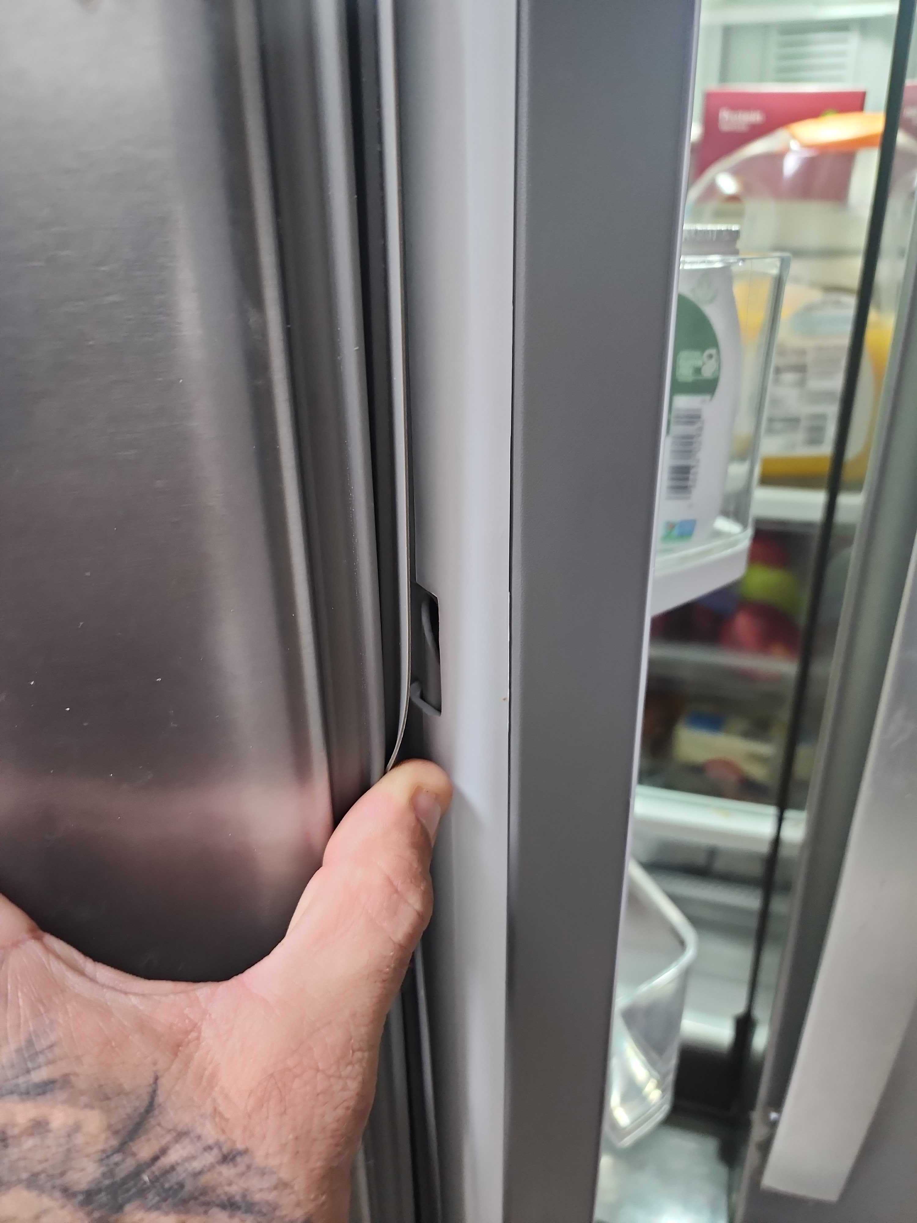 Whirlpool refrigerator door and mullion area being inspected for closure issue in Coconut Creek FL RR0090