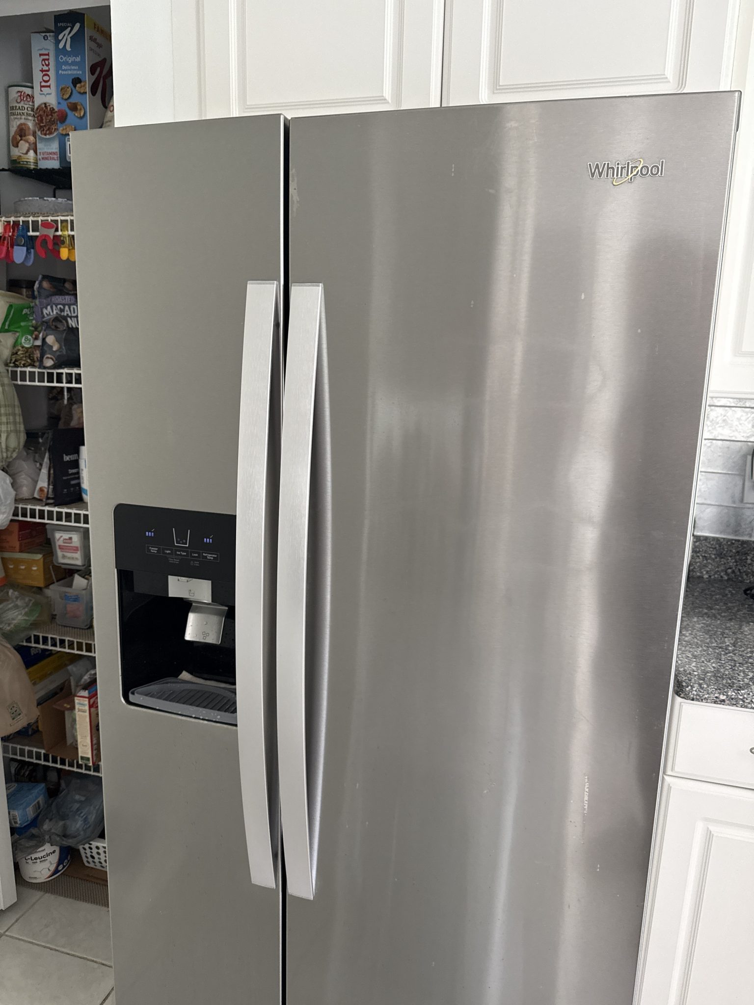 A stainless steel Whirlpool side-by-side refrigerator located in a Margate, FL kitchen, successfully repaired for a non-dispensing water issue.